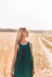 © Olya Komarova - Beautiful teenage girl with long white hair walking through a wheat field on a sunny day