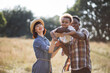 © sofiko14 - Beautiful multicultural wife and husband laughing and playing with pretty son on fresh air. Happy parents enjoying summer days on field with lovely black child.