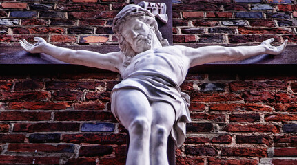 Sticker - Bottom view of ancient statue of the crucifixion of Jesus Christ.