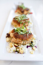 A Trio Of Crab Cakes With Corn Relish