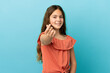 © luismolinero - Little caucasian girl isolated on blue background making money gesture