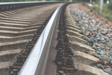 Railway Rails And Sleepers Close-up. A Railway That Goes Around A Bend In The Distance.