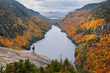 © Tandem Stock - A hiker overlooking Lower Ausable Lake in New York's Adirondack Mountains.