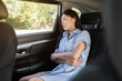 © geargodz - woman sleeping while sitting in the back seat of car