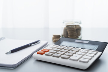 Aufkleber - Calculator and money in glass jar.　Household finance management and saving money.