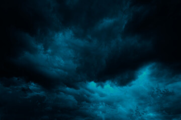 Wall Mural - dramatic blue green sky. gloomy heavy thunderclouds. dark teal sky background with copy space for de