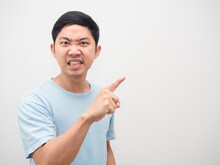 Man Angry Face Looking And Point Finger At Copy Space White Background