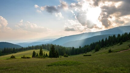 Wall Mural - Time lapse at sunset with beautiful moving clouds over the tree-covered mountain slopes, the Rhodopes in Bulgaria