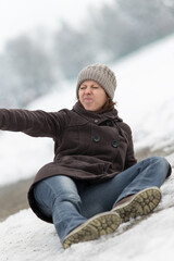 Wall Mural - young woman lying on a icy street and appeal for help