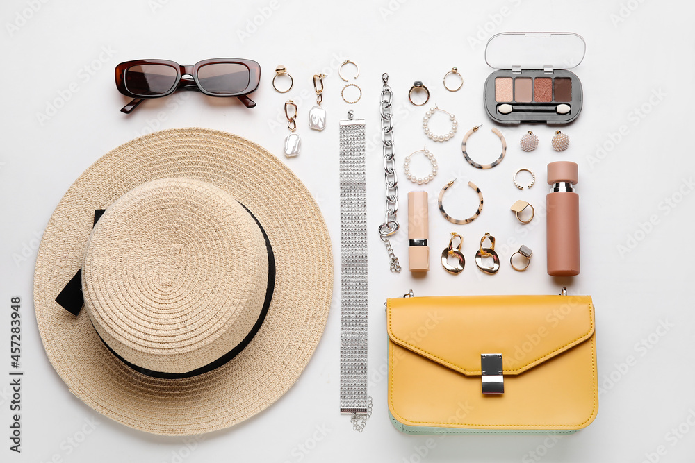 Set of female accessories and cosmetics on white background