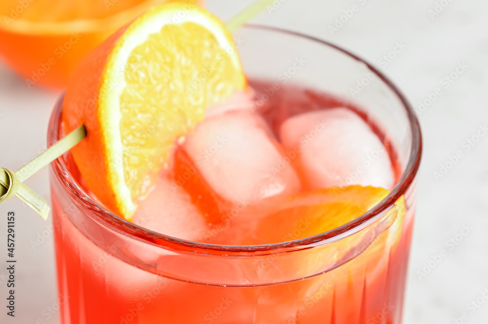 Glass of tasty Negroni cocktail on light background, closeup
