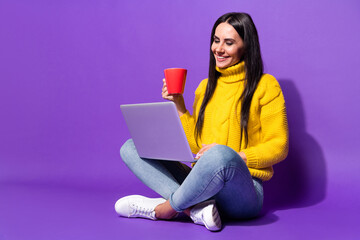 Sticker - Full body portrait of adorable satisfied person hold coffee mug look laptop isolated on purple color background