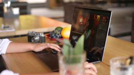Fototapete - Freelancer retoucher woman works on convertible laptop computer with photo editing software using stylus. Photographer or designer digital image processing. 2 in 1 with touch screen in tent mode.