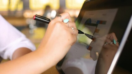 Fototapete - Businesswoman hand pointing with stylus on the chart over convertible laptop screen in tent mode. Woman using 2 in 1 notebook with touchscreen for work on business presentation. Isolated close view.