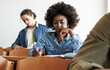 © BalanceFormCreative - Young black female student taking a test in university classroom.