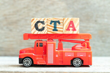 Fire Ladder Truck Hold Letter Block In Word CTA (Abbreviation Of Call To Action Or Chartered Tax Adviser) On Wood Background