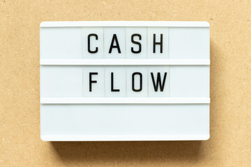 Canvas Print - Lightbox with word cash flow on wood background