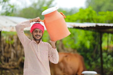 Canvas Print - Young indian milk man at his farm