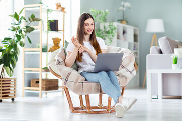 Wall Mural - Portrait of attractive cheerful girl sitting in chair using laptop discussing conference at home light living room indoors