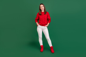 Poster - Full length photo of young attractive girl happy positive smile hands in pocket confident isolated over green color background