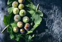 Fresh Figs Placed On Top Of Green Leaves