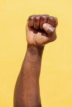 Vertical Photo Of A Raised Fist Of A Black Man