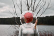 © ADDICTIVE STOCK - Woman in astronautic suit walking near water