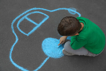 Poster - Child drawing car with chalk on asphalt