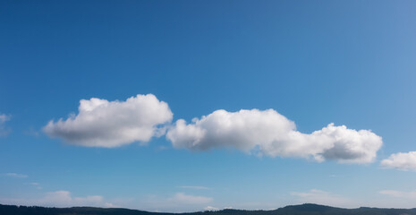 Wall Mural - Panoramic View of Puffy White Clouds with Blue Sky during a beautiful Sunny Summer Day. Taken over the coast of British Columbia, Canada. Nature Background Panorama