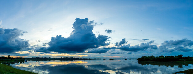 Wall Mural - panorama landscape, beautiful sunset sky on the river, sky clouds background over river