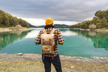 Tourist From His Back Looks At Beautiful And Calm Turquoise Lake
