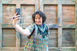 © Cavan Images - modern middle-aged woman taking a photo from her smartphone