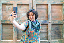 Modern Middle-aged Woman Taking A Photo From Her Smartphone