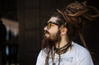 © Cavan Images - portrait of a hipster guy with glasses and with dreadlocks and a