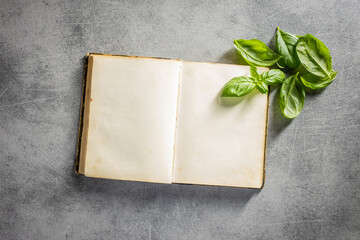 Wall Mural - Blank recipe book. Cookbook and green basil leaves.