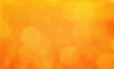 Autumn bokeh light background. Holiday glowing backdrop. Orange defocused, blurred bokeh