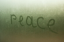 Inscription Peace On A Wet Glass Closeup