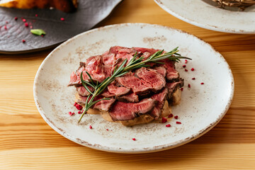 Wall Mural - grilled steak with vegetables, sauce, herbs.