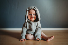 Adorable Smiling Baby Wearing A Bunny Jumper For Easter