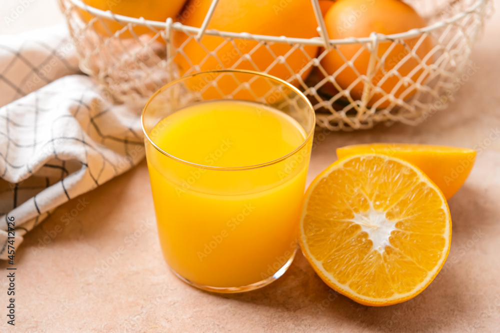 Glass with tasty orange juice on color background