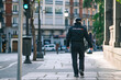 © Cavan Images - Policewoman member of the Spanish security forces and bodies walking down a city street