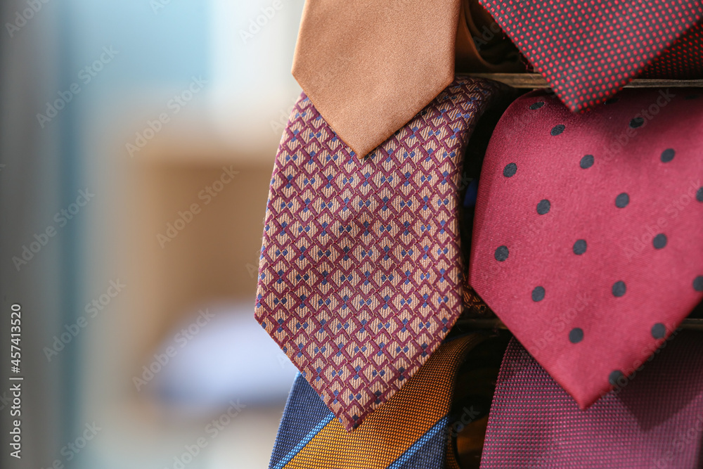 Box with many stylish neckties, closeup