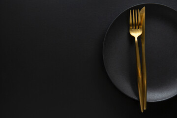 Poster - Golden cutlery set with dark plate