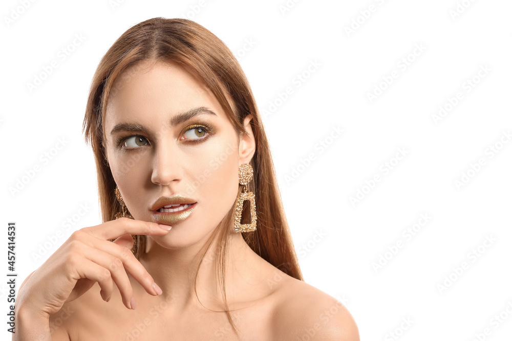 Beautiful young woman with  golden makeup on white background