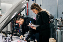 Male Mechanic Teaches Female Mechanic How To Fix A Vehicle