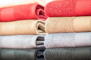 Leinwandbilder - Colorful folded towels stack closeup picture.