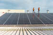 © Cavan Images - Unrecognizable solar panel technicians checking a Spanish factory