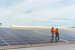 © Cavan Images - Unrecognizable solar panel technicians cheking Spanish installation
