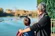 © Cavan Images - Mother with her son looking at the boats