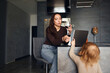 © Cavan Images - Brunette woman drinking wine and using laptop
